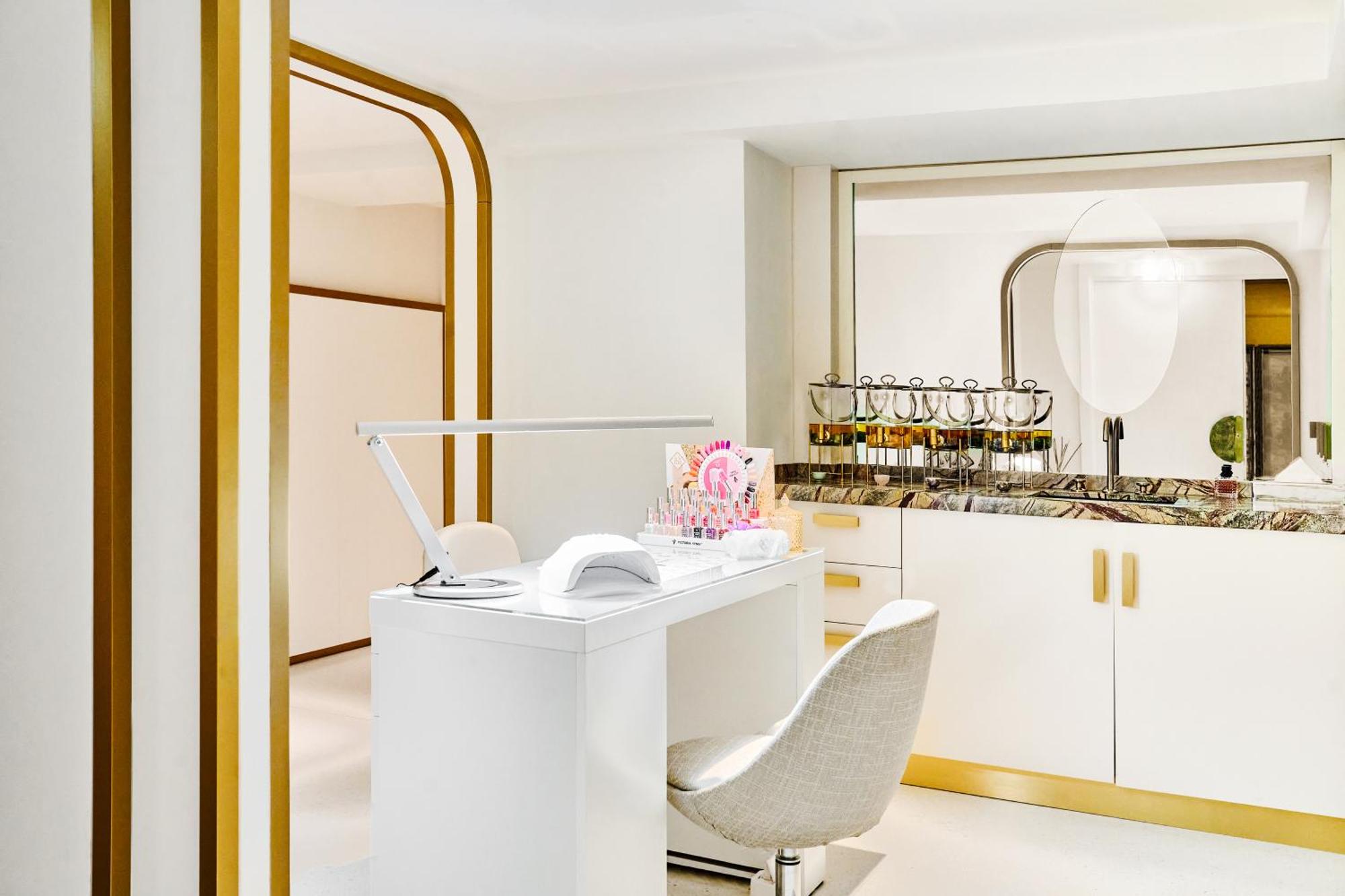 una scrivania bianca con sedia e specchio di Carlton Cannes, a Regent Hotel a Cannes